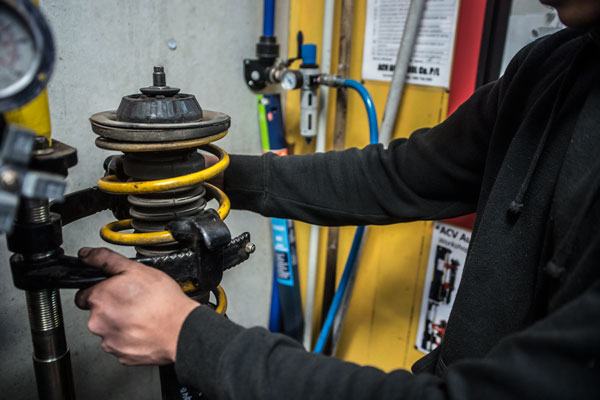 mechanic fixing car spring suspension