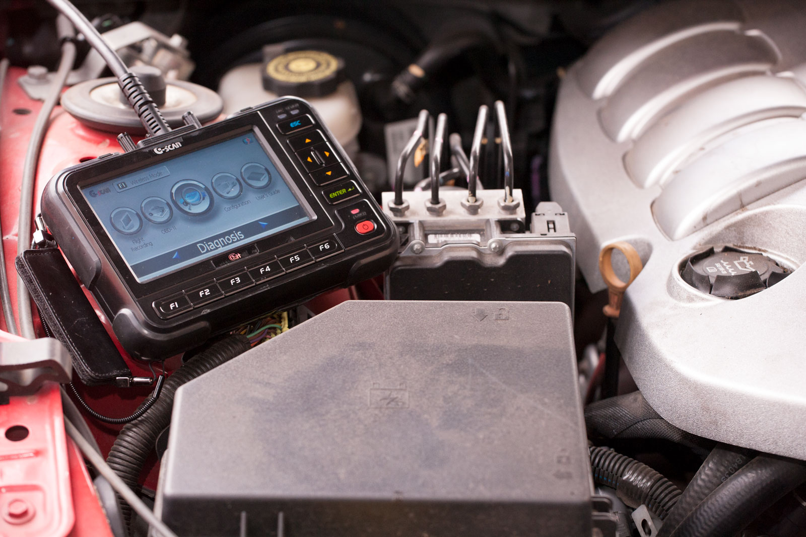 diagnostic tool resting in engine bay